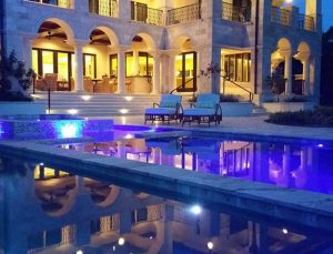 #D rendering of a pool and pool deck at night time